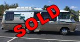 White GMC Motorhome photograph with a red SOLD label