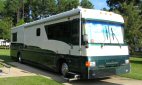 White Country Coach motorhome viewed from the front right