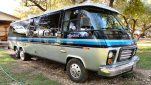Blue and silver stretched GMC Motorhome viewed from the front